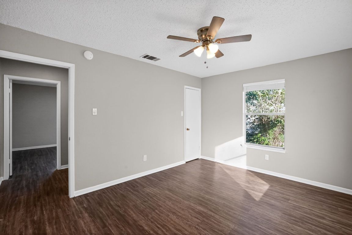 1505 Timber Street Georgetown, TX 78626 - Photo 6 of 22 Unfurnished room with dark wood-style flooring, a textured ceiling, and a ceiling fan