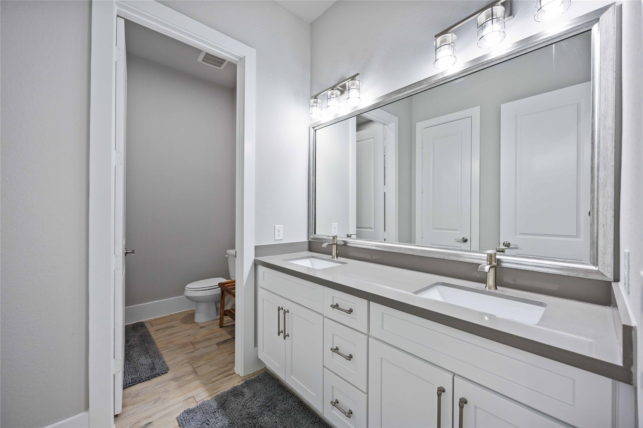 33510 Walnut Crossing Magnolia, TX 77355 - Photo 20 of 50 Perfect for guests or daily use, this well-designed secondary bathroom includes a separate vanity area, offering both convenience and enhanced privacy.