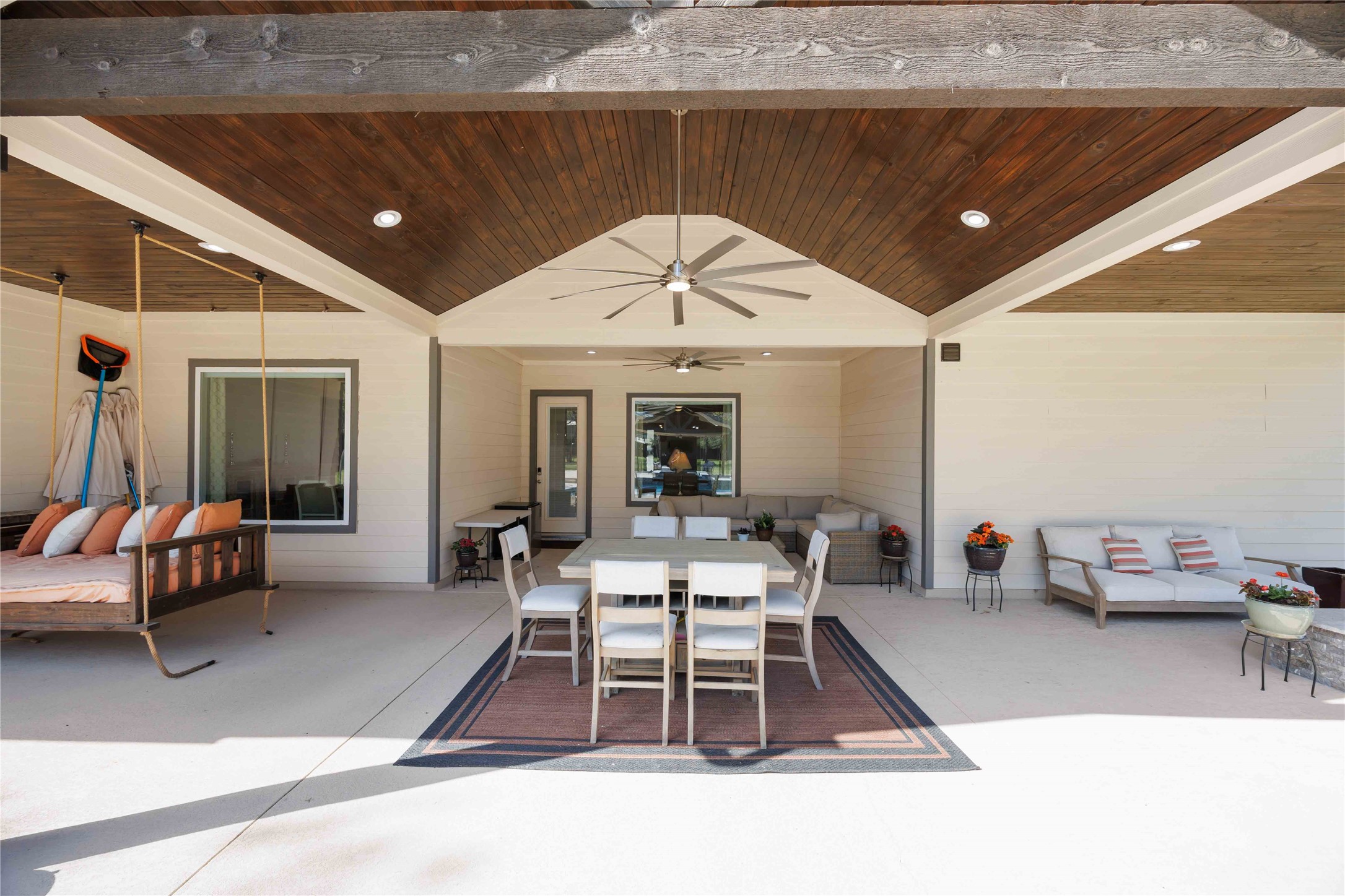 33510 Walnut Crossing Magnolia, TX 77355 - Photo 29 of 50 Enjoy a spacious covered patio with multiple seating areas, perfect for relaxing or entertaining while overlooking the pool and backyard.