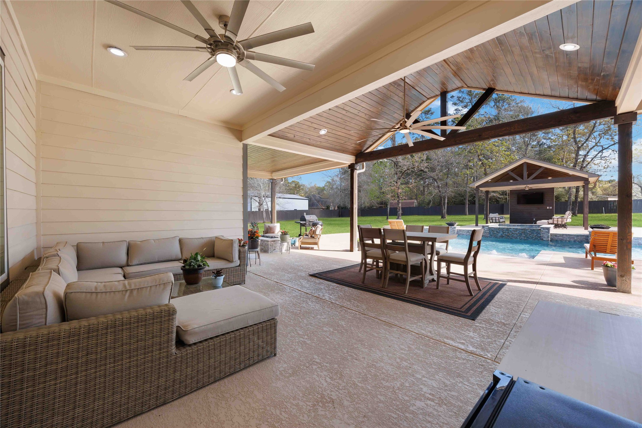 33510 Walnut Crossing Magnolia, TX 77355 - Photo 32 of 50 Host with ease on the expansive patio featuring multiple seating areas that open seamlessly to the backyard and pool.