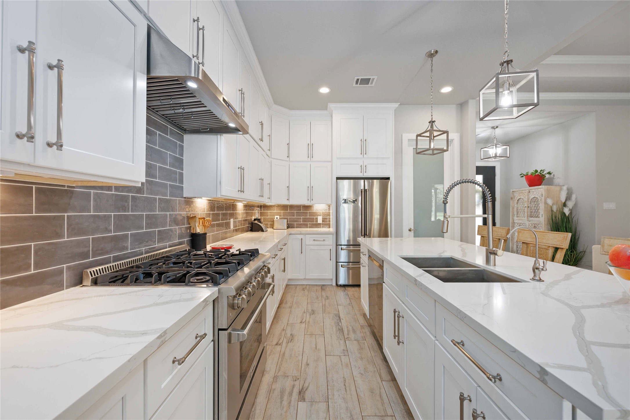 33510 Walnut Crossing Magnolia, TX 77355 - Photo 8 of 50 Cook with ease on the gas cooktop while staying connected to the heart of the home.