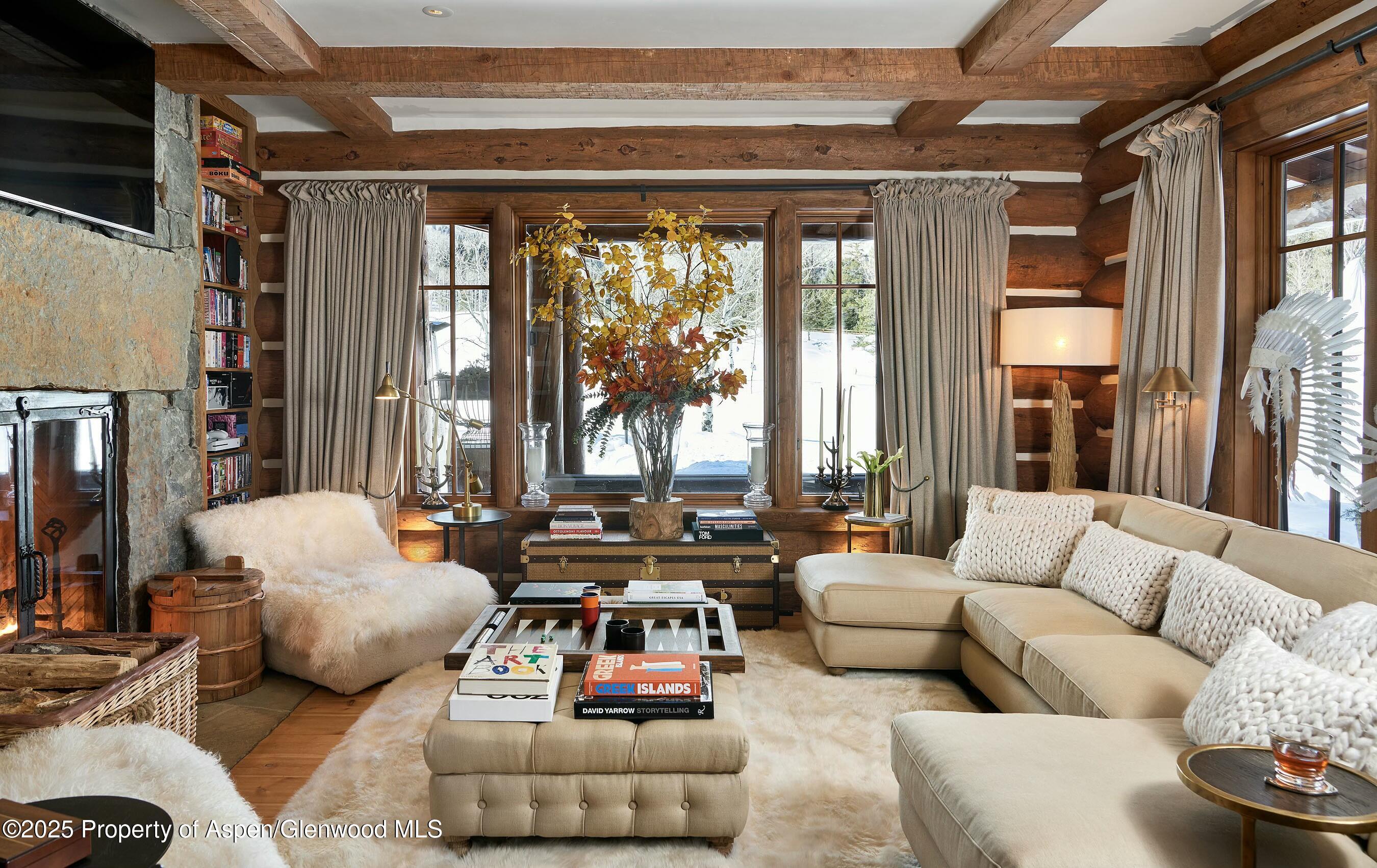 6855 Capitol Creek Road Snowmass, CO 81654 - Photo 11 of 41 a living room with furniture and a large window