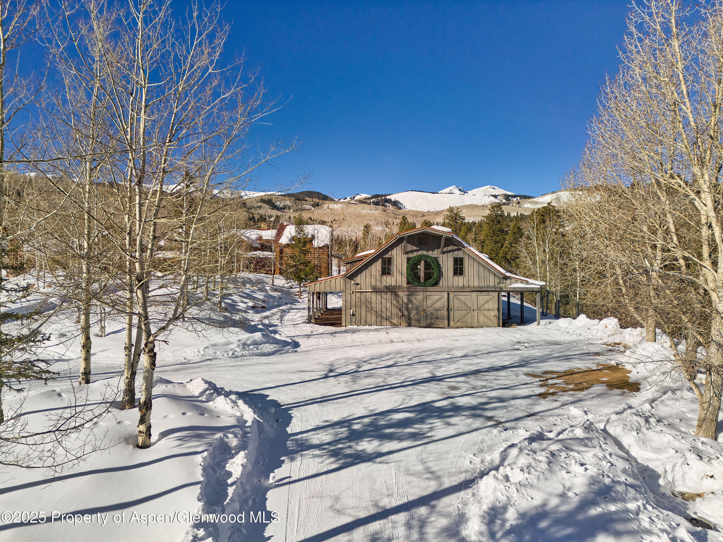 6855 Capitol Creek Road Snowmass, CO 81654 - Photo 4 of 41 a view of a house with a yard