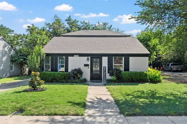 a front view of a house with garden and porch