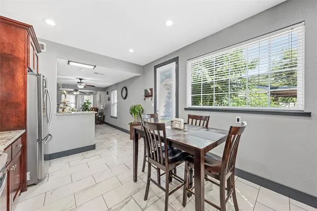 a dining room with furniture and window