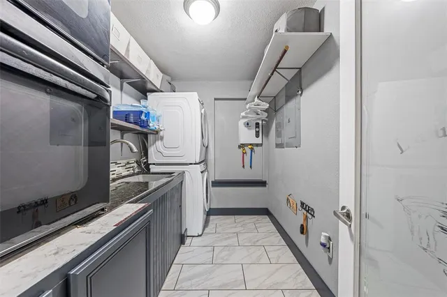 a kitchen with granite countertop a stove and a refrigerator