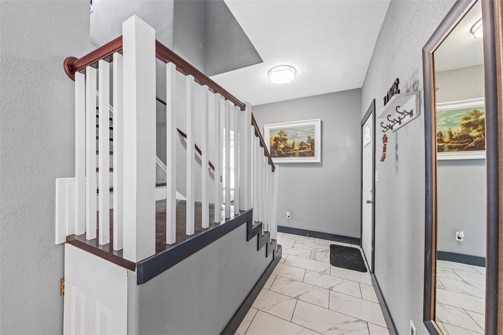 1205 North 17th Street Waco, TX 76707 - Photo 18 of 38 Hallway with light marble finish floors and stairway