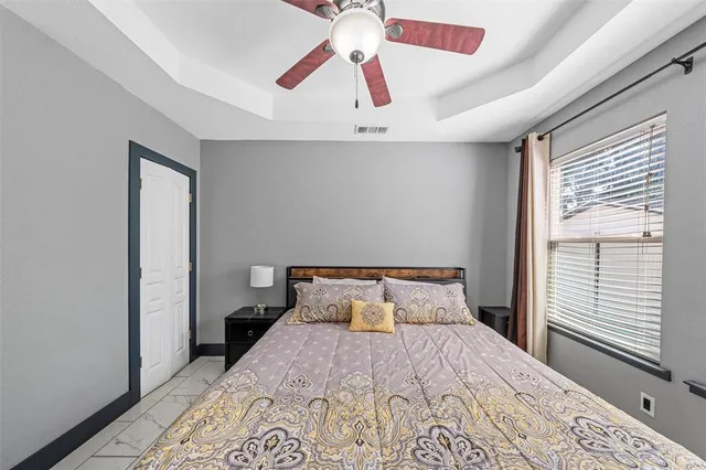 a bedroom with a bed and a chandelier