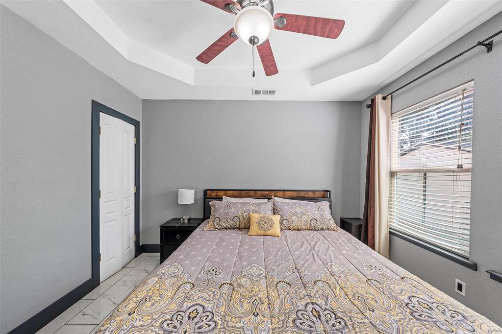 1205 North 17th Street Waco, TX 76707 - Photo 19 of 38 Bedroom with a raised ceiling, light marble finish floors, and ceiling fan