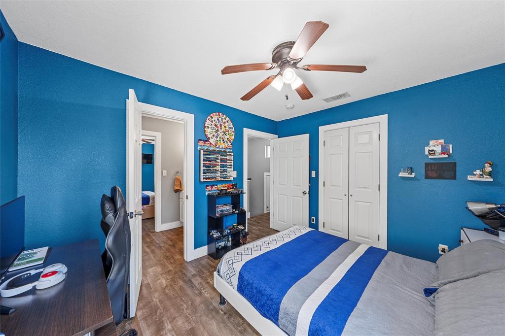 1205 North 17th Street Waco, TX 76707 - Photo 23 of 38 Bedroom featuring wood finished floors, a textured wall, a closet, a ceiling fan, and an office area