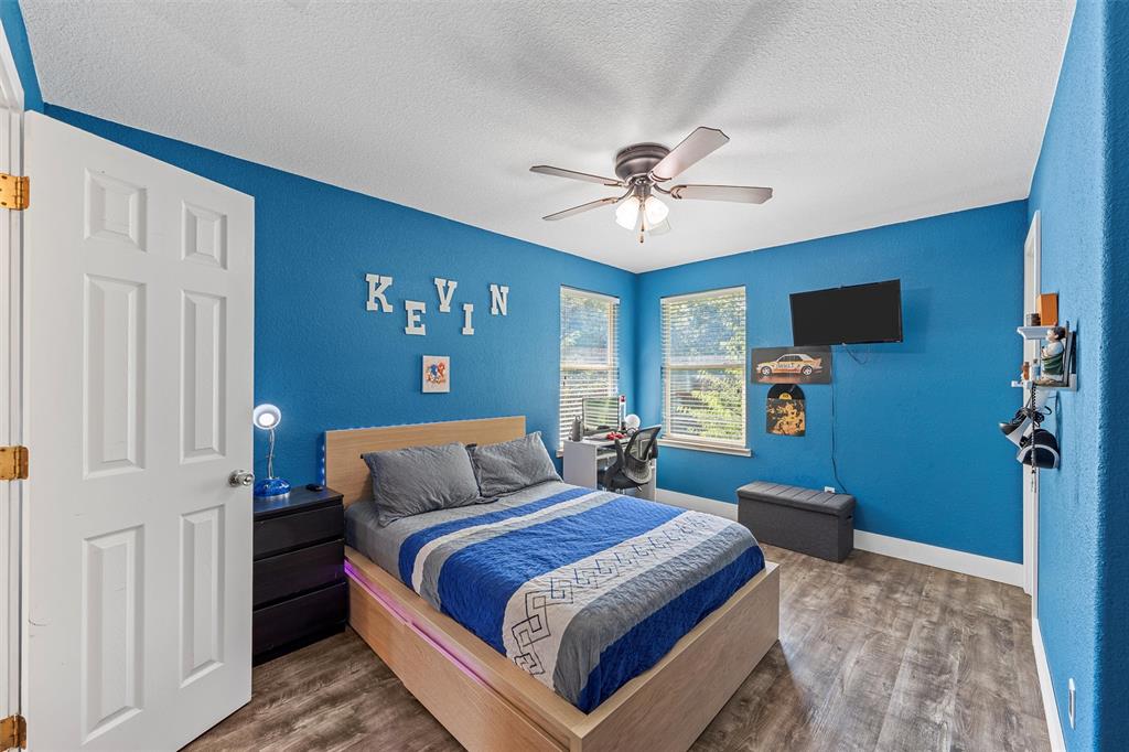 1205 North 17th Street Waco, TX 76707 - Photo 26 of 38 Bedroom with wood finished floors, a textured ceiling, a textured wall, and a ceiling fan