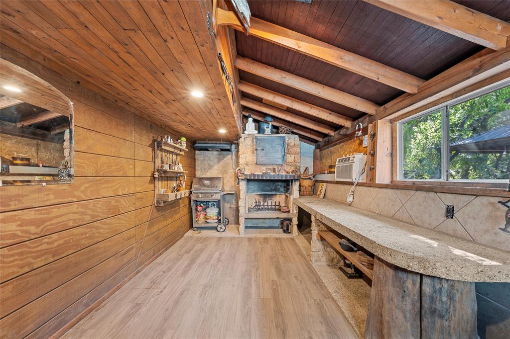 1205 North 17th Street Waco, TX 76707 - Photo 30 of 38 Bar featuring wooden ceiling, wood walls, wood finished floors, and exhaust hood
