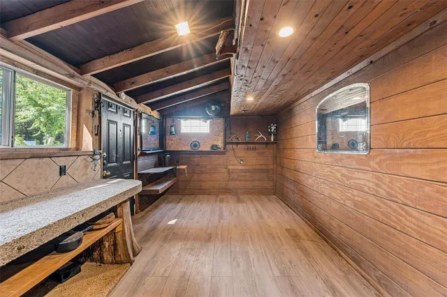 a view of a hallway with wooden floor and furniture