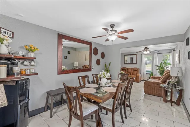 a view of a dining room with furniture and a potted plant