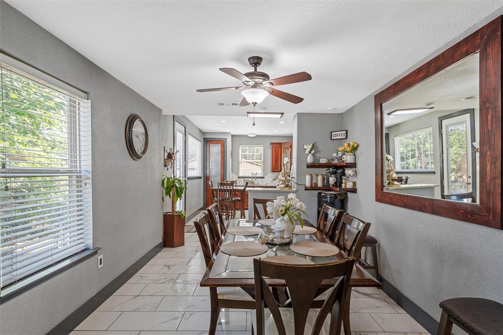 1205 North 17th Street Waco, TX 76707 - Photo 7 of 38 Dining area featuring a textured wall, healthy amount of natural light, light marble finish floors, and a ceiling fan