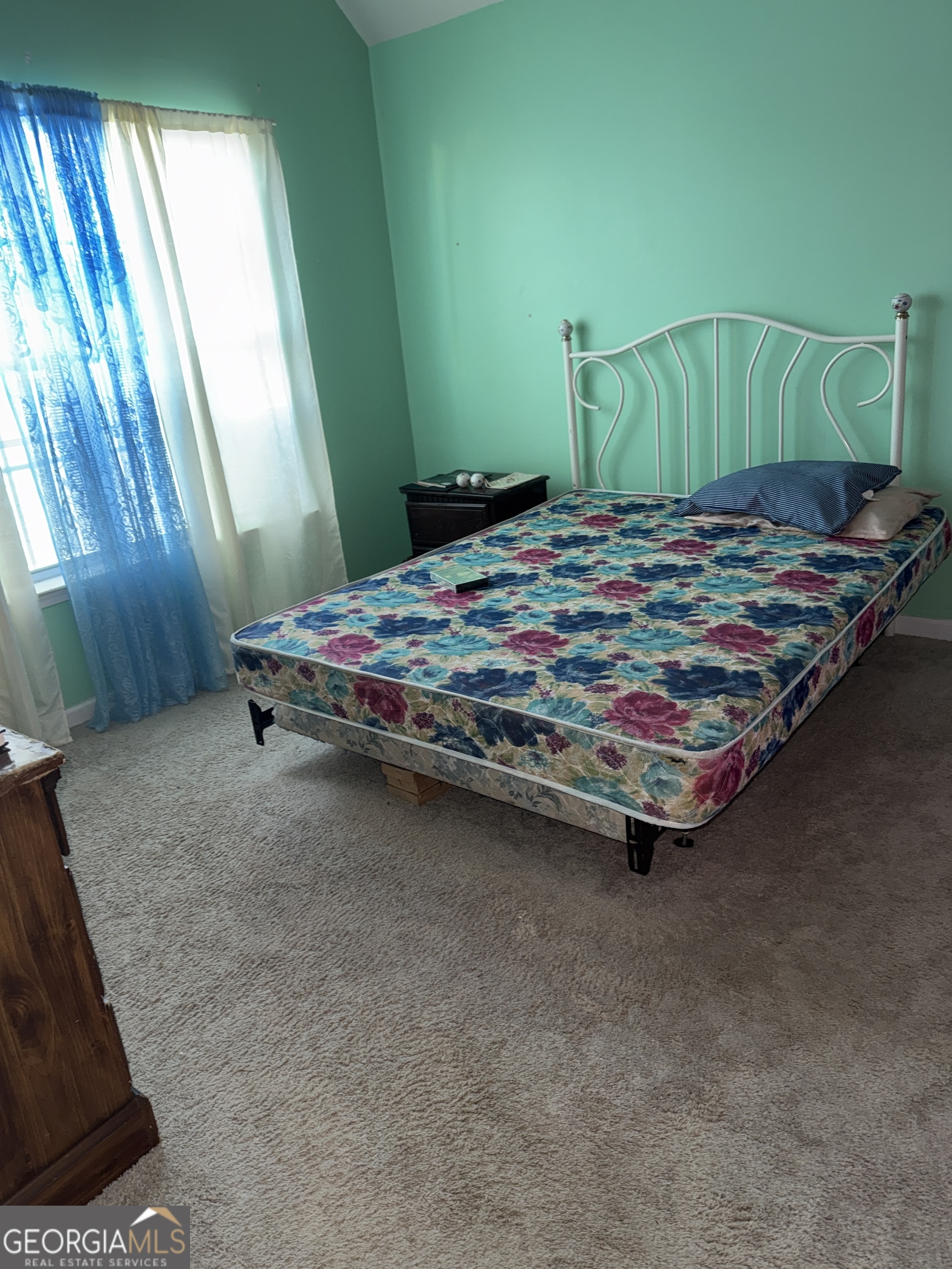 11631 Kades Trail Hampton, GA 30228 - Photo 3 of 5 a bed sitting in a bedroom next to a window