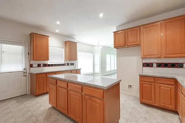 a kitchen with stainless steel appliances granite countertop a sink and cabinets