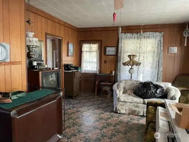 a living room with furniture ceiling fan and a window
