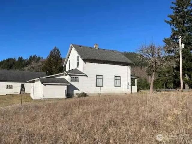 a view of a house with wooden fence