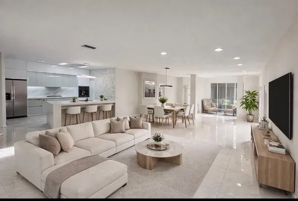 a living room with furniture kitchen view and a flat screen tv