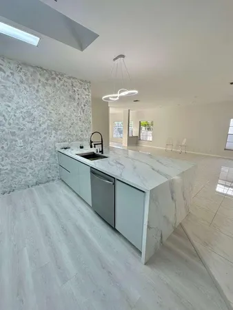 a view of a livingroom with an empty space and a window