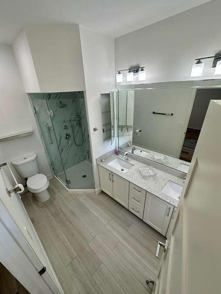 7660 Mansfield Hollow Road Delray Beach, FL 33446 - Photo 18 of 30 a bathroom with a double vanity sink mirror and toilet