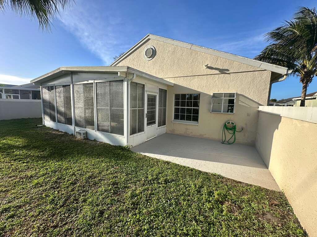 7660 Mansfield Hollow Road Delray Beach, FL 33446 - Photo 29 of 30 a view of a white house with a yard