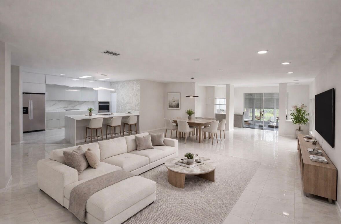 7660 Mansfield Hollow Road Delray Beach, FL 33446 - Photo 3 of 30 a living room with furniture kitchen view and a flat screen tv