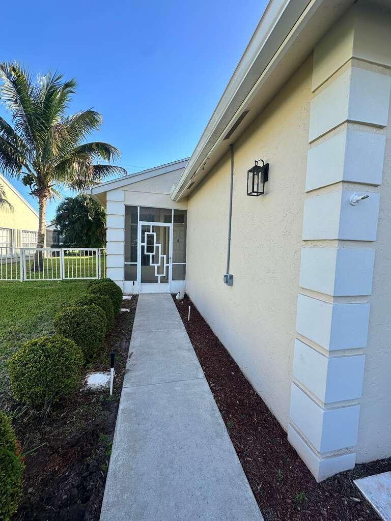 7660 Mansfield Hollow Road Delray Beach, FL 33446 - Photo 4 of 30 a view of a house with a yard
