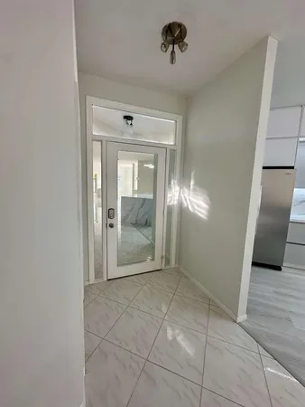 a large kitchen with kitchen island a sink stainless steel appliances and cabinets