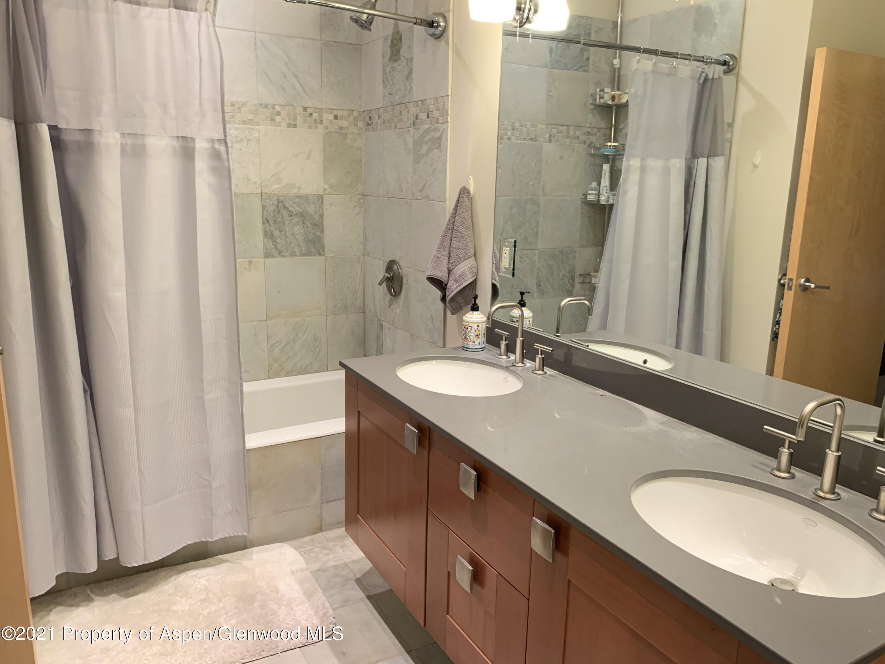 231 Robinson Street, Unit R302 Basalt, CO 81621 - Photo 19 of 31 a bathroom with a granite countertop sink shower and a mirror