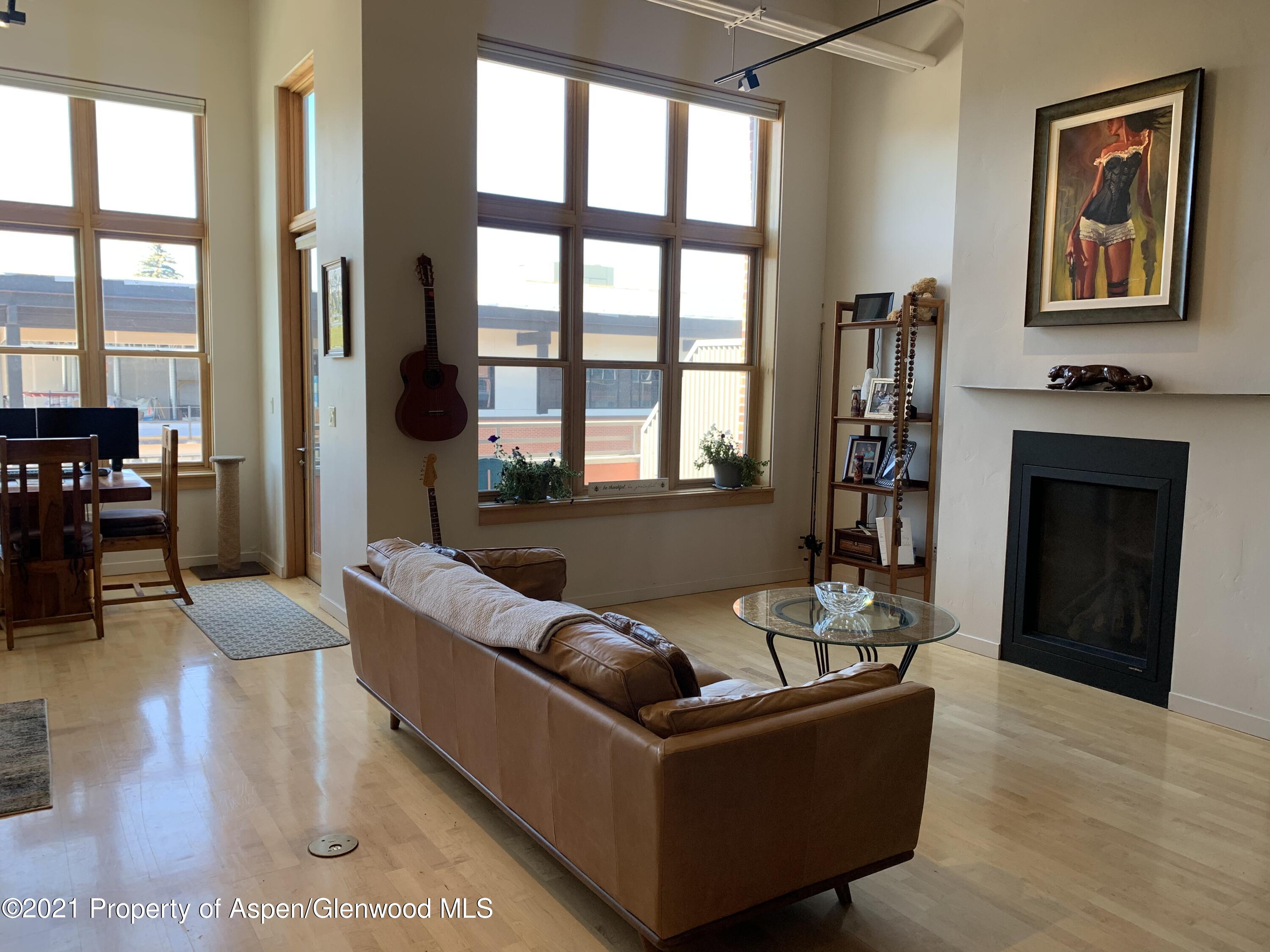 231 Robinson Street, Unit R302 Basalt, CO 81621 - Photo 2 of 31 a living room with furniture and a fireplace