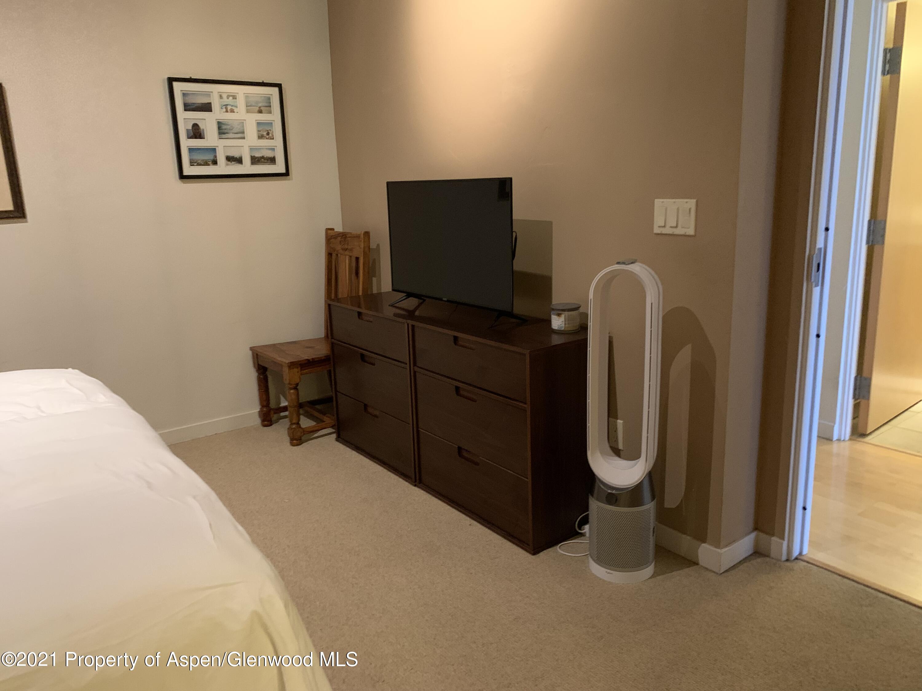 231 Robinson Street, Unit R302 Basalt, CO 81621 - Photo 22 of 31 a room with a flat screen tv and a window