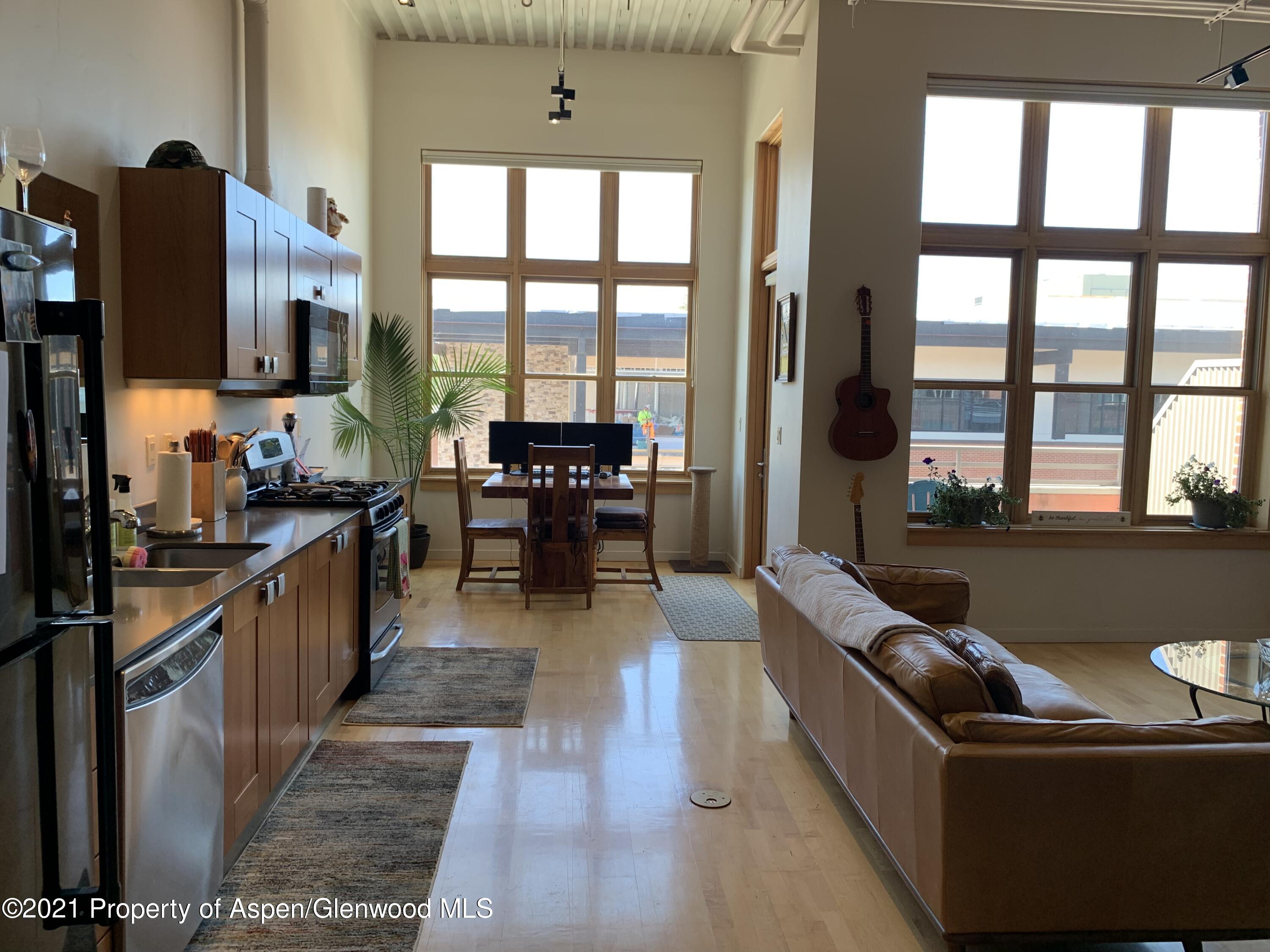 231 Robinson Street, Unit R302 Basalt, CO 81621 - Photo 23 of 31 a living room with furniture tv and a large window