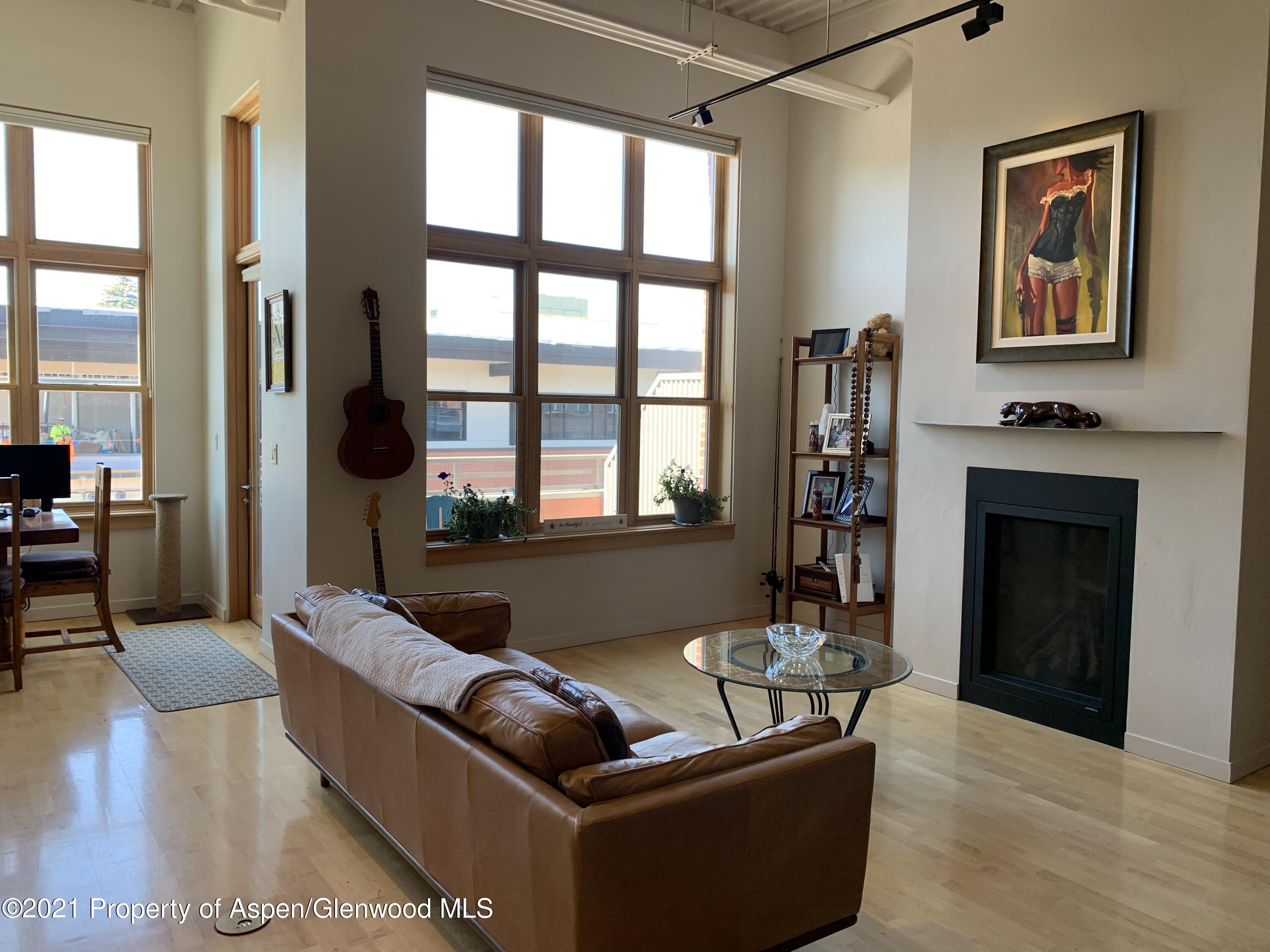231 Robinson Street, Unit R302 Basalt, CO 81621 - Photo 24 of 31 a living room with furniture and a fireplace