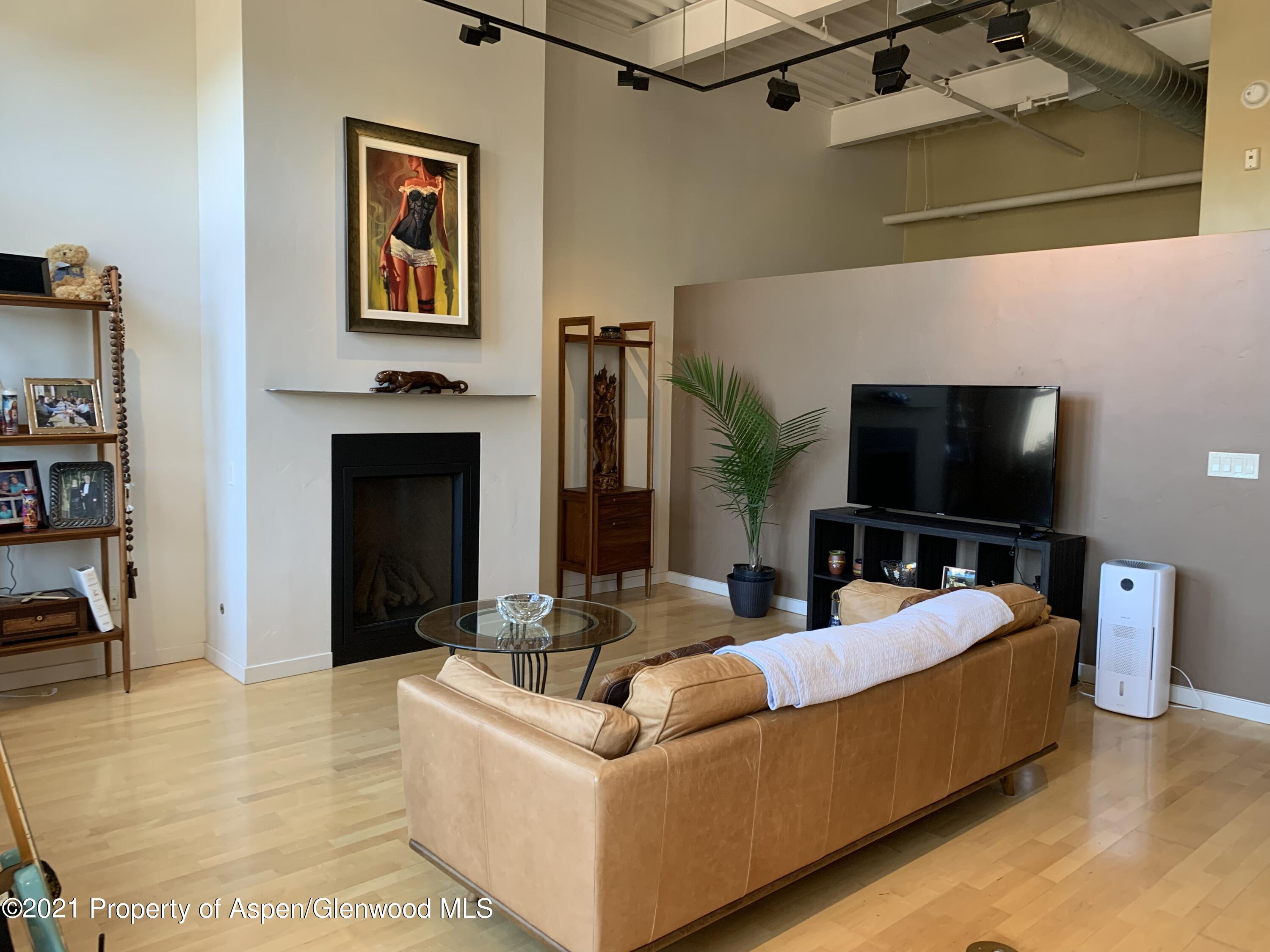 231 Robinson Street, Unit R302 Basalt, CO 81621 - Photo 7 of 31 a living room with furniture and a flat screen tv