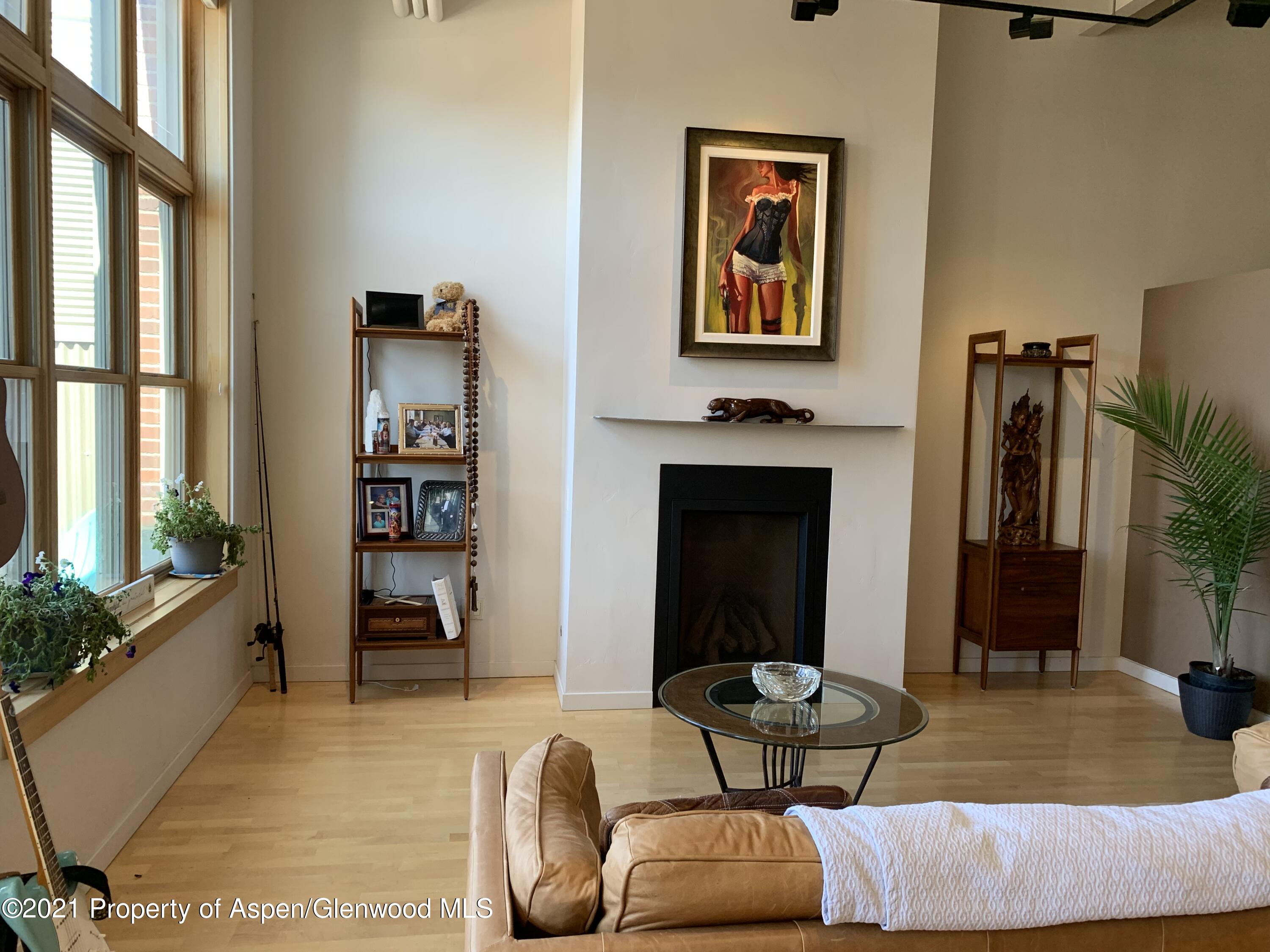 231 Robinson Street, Unit R302 Basalt, CO 81621 - Photo 8 of 31 a living room with furniture and a fireplace