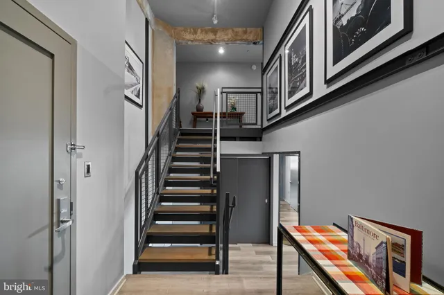 a view of a dining room with furniture large windows and wooden floor