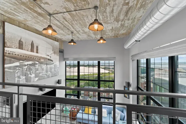a living room filled with furniture and a floor to ceiling window