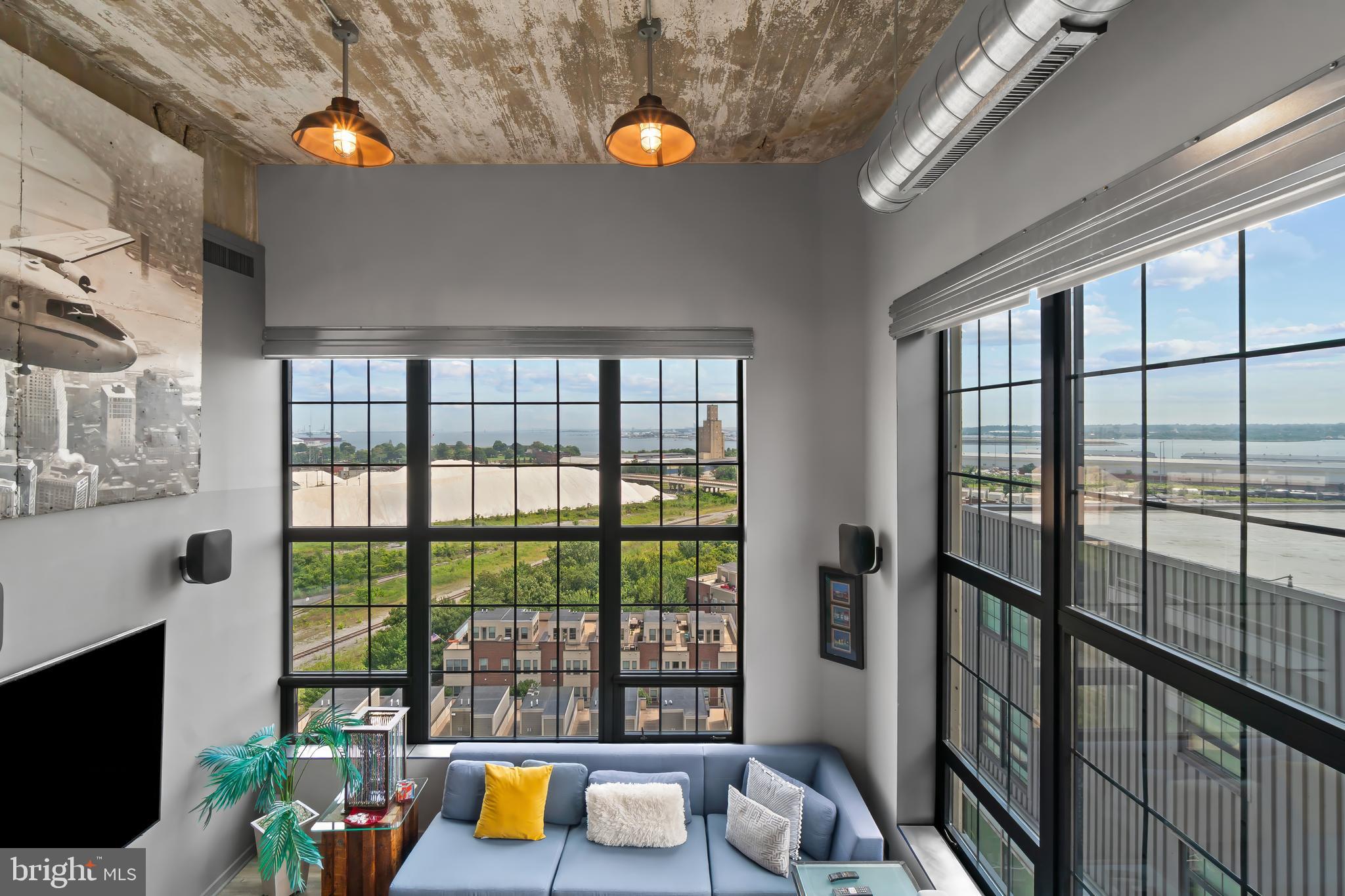 1200 Steuart Street, Unit 1119 Baltimore, MD 21230 - Photo 17 of 37 a living room filled with furniture and a floor to ceiling window