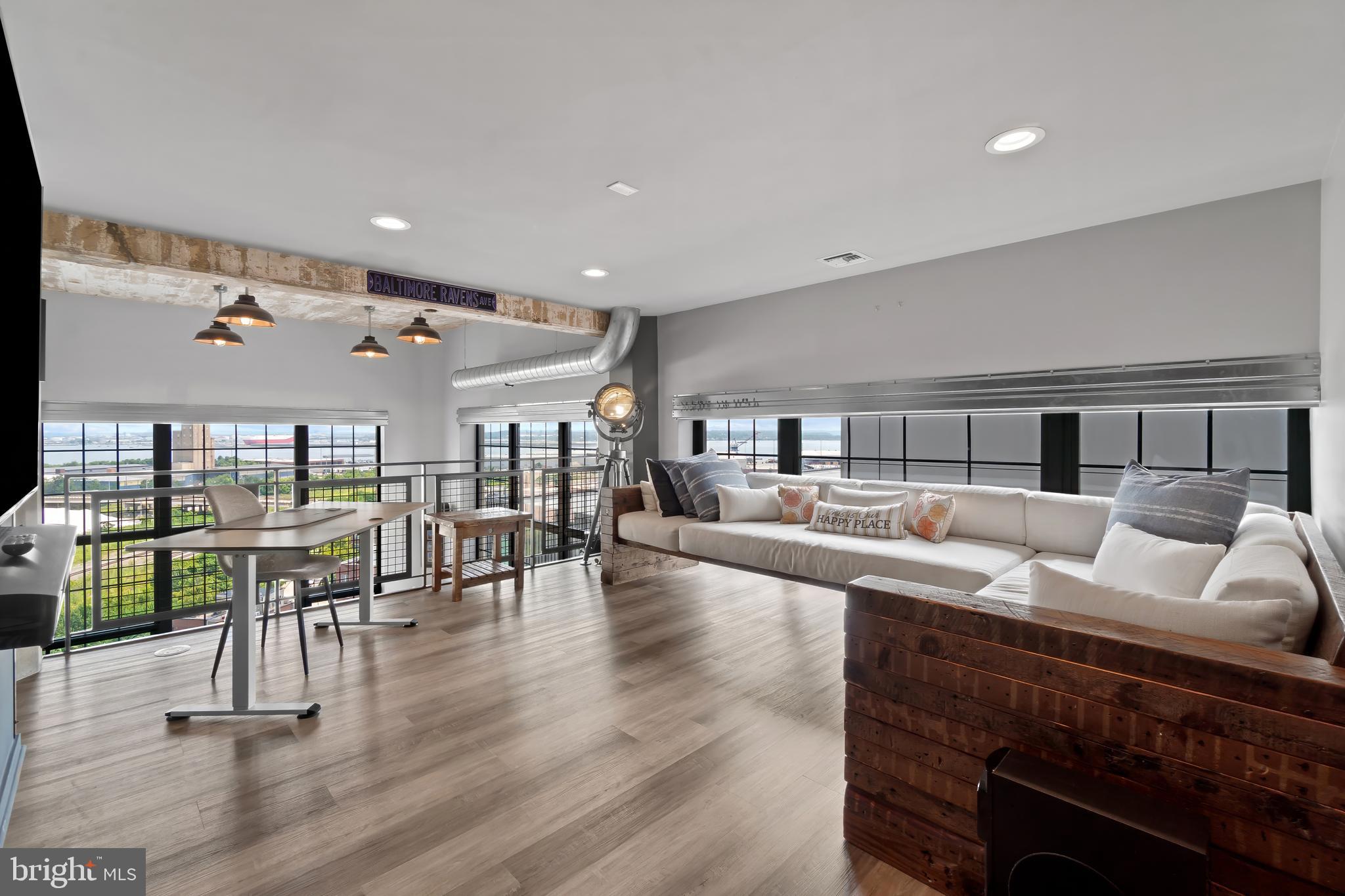 1200 Steuart Street, Unit 1119 Baltimore, MD 21230 - Photo 18 of 37 a living room with furniture and wooden floor