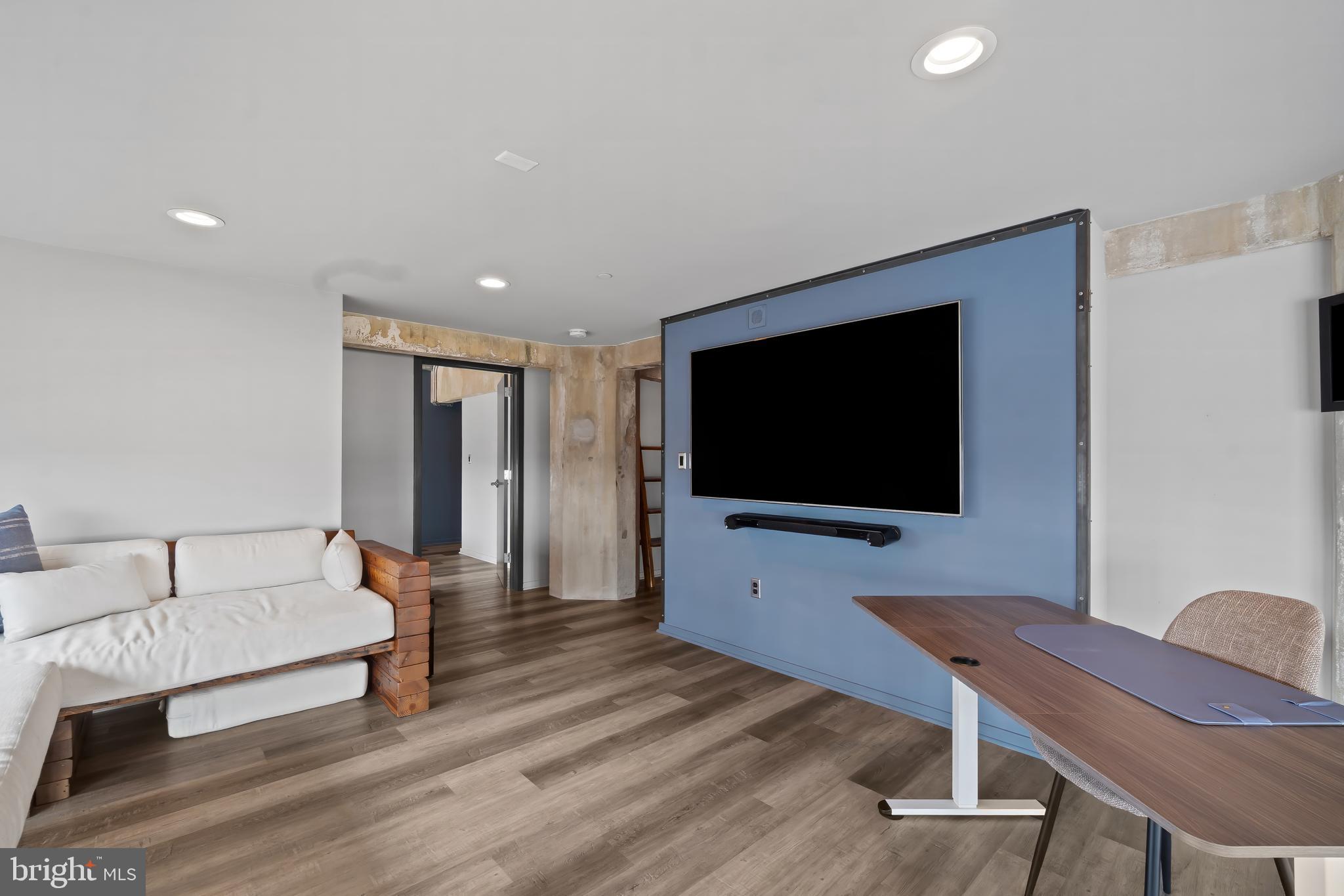 1200 Steuart Street, Unit 1119 Baltimore, MD 21230 - Photo 19 of 37 a living room with furniture and a flat screen tv