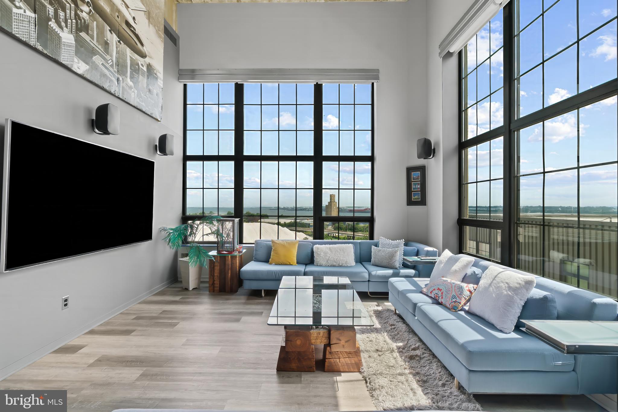 1200 Steuart Street, Unit 1119 Baltimore, MD 21230 - Photo 2 of 37 a living room with furniture tv and a large window