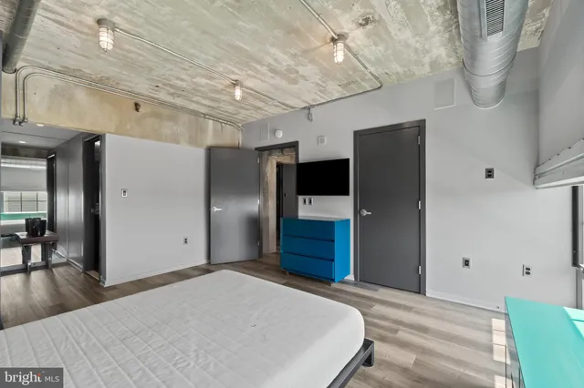 a bed room with furniture and a flat screen tv