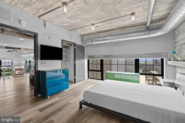 a room with pool table and windows