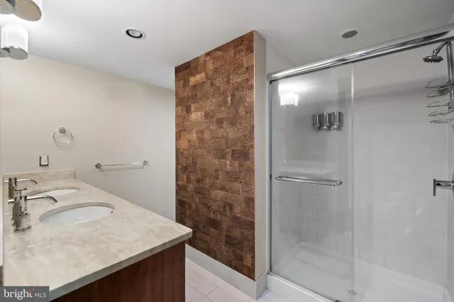 a bathroom with a sink double vanity and a mirror