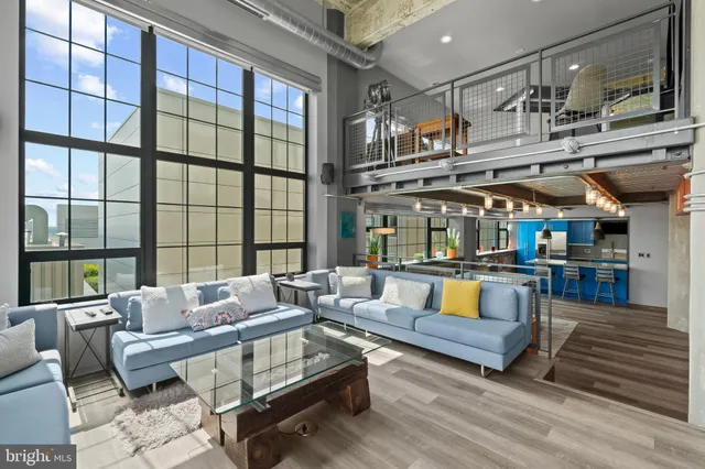 a living room with furniture and a floor to ceiling window