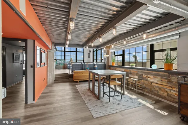 a living room with furniture a window and a chandelier