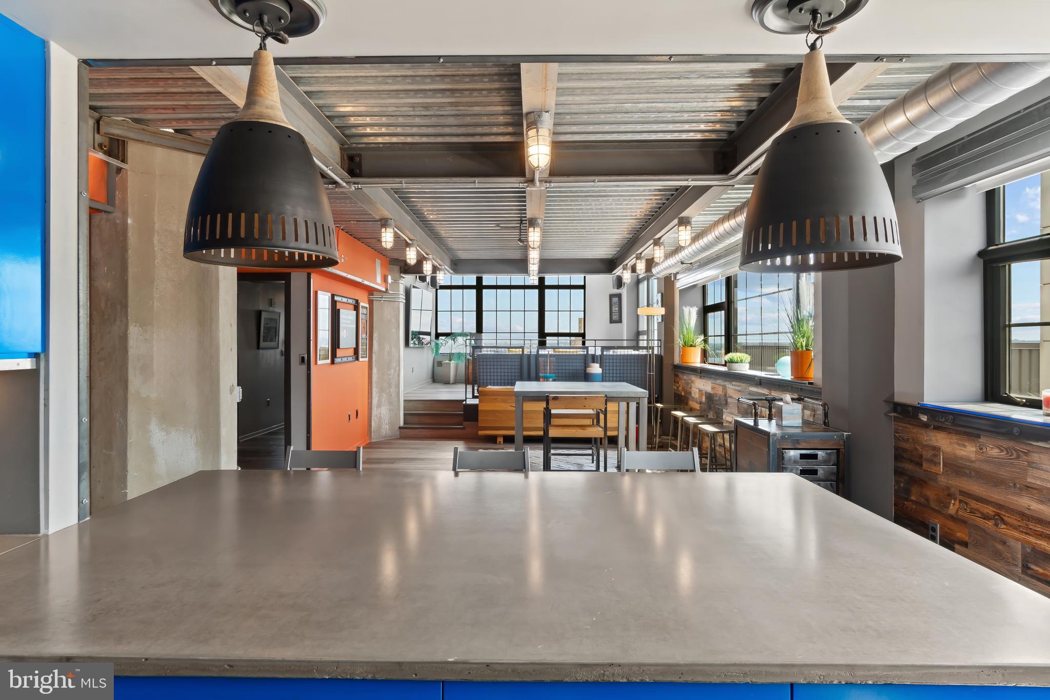 1200 Steuart Street, Unit 1119 Baltimore, MD 21230 - Photo 6 of 37 a living room with furniture a window and a chandelier