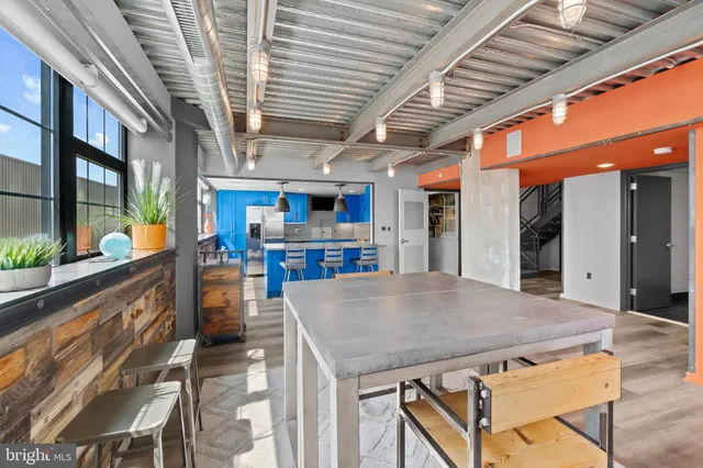 a view of a hallway with wooden floor and entryway